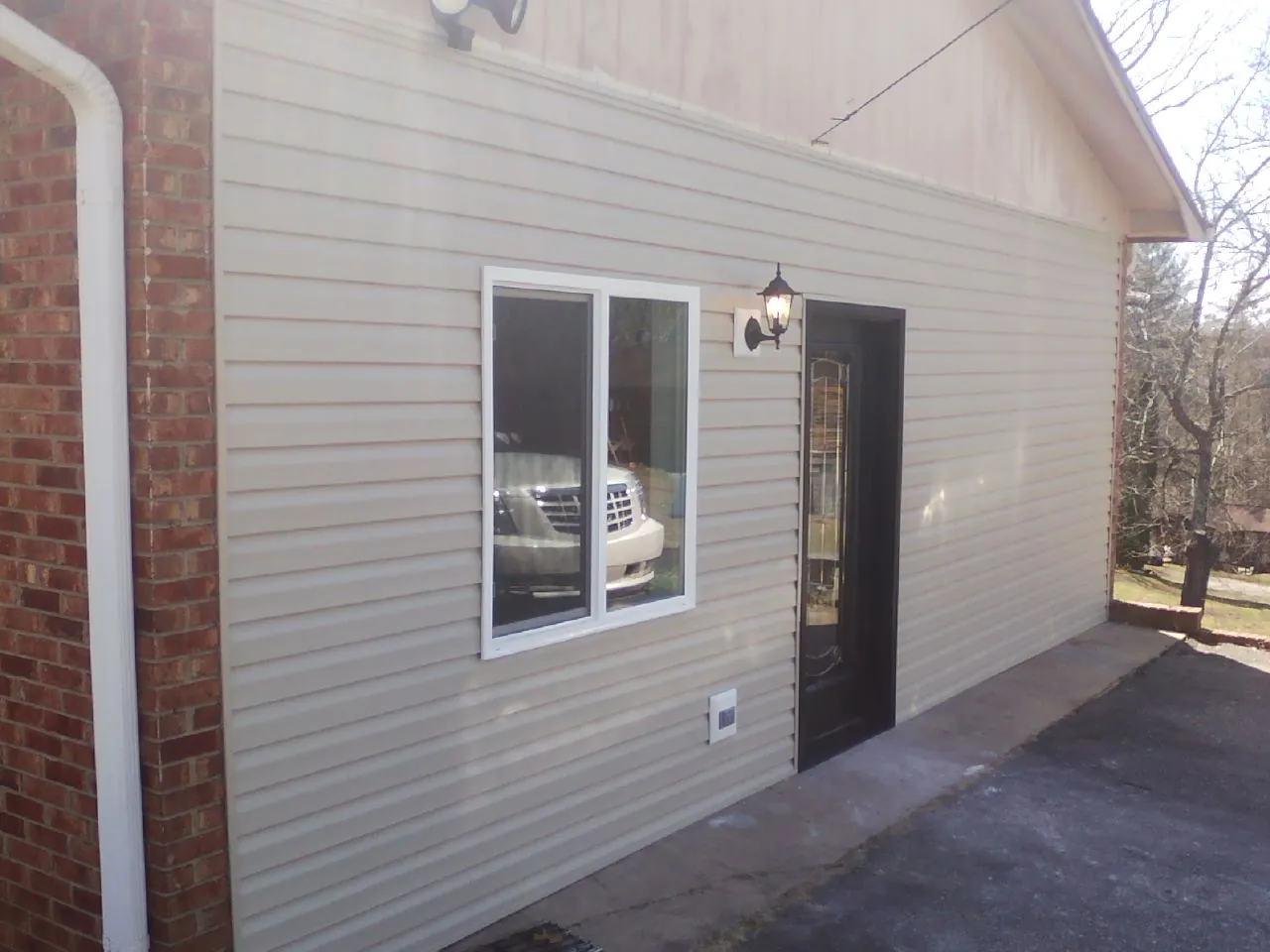 New vinyl siding and entry door on a room addition in Seaton
