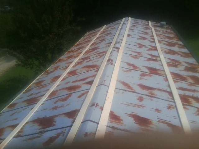 Rusted metal roof panels with new wood purlins before replacement — Storm Damage Roof Repair in Seaton by Roofing Brothers