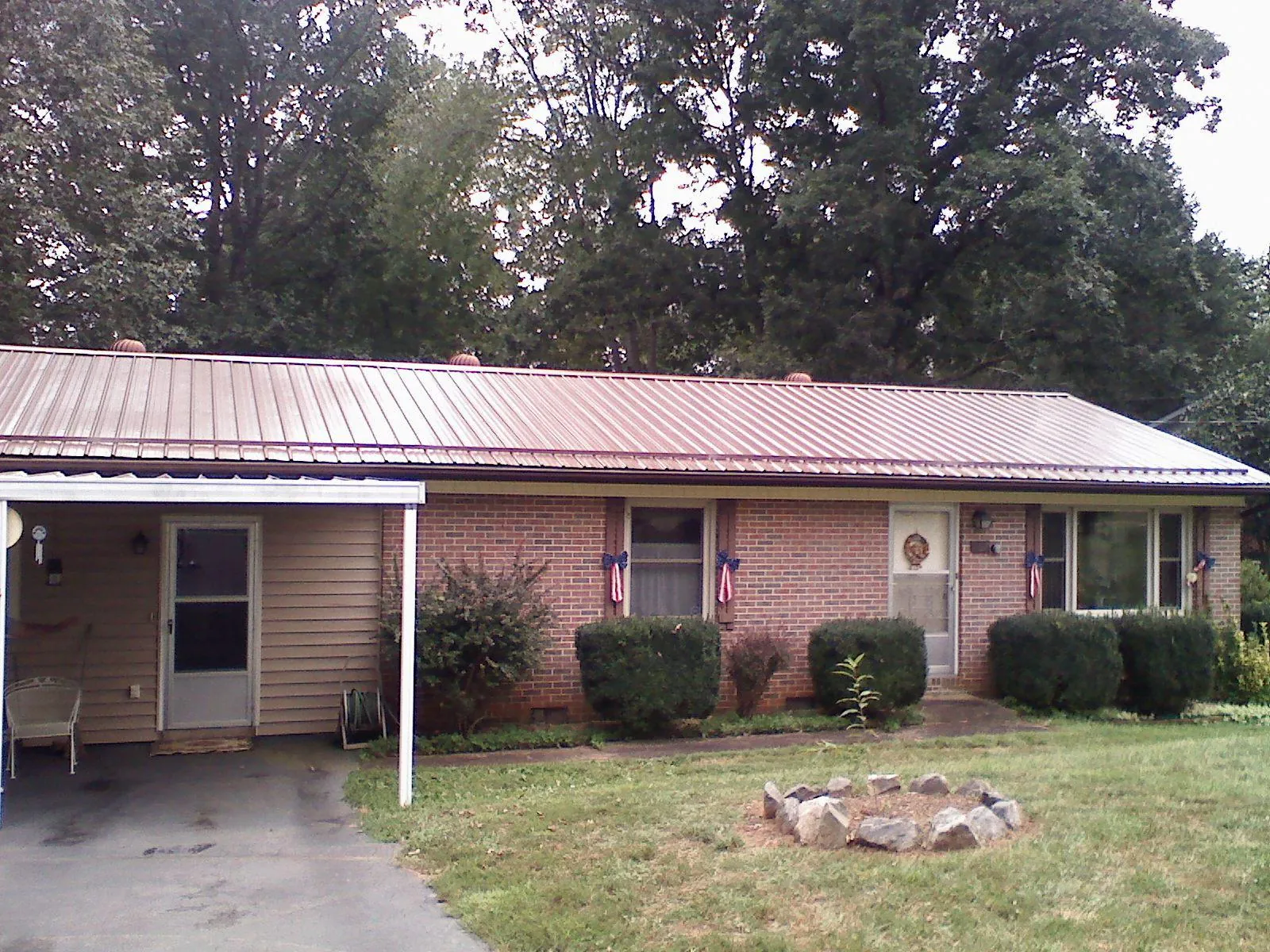 Bronze metal roof and carport on a brick ranch home — Roof Repair work by our crew in Seaton